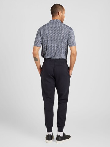 Effilé Pantalon de sport 'Unstoppable' UNDER ARMOUR en noir