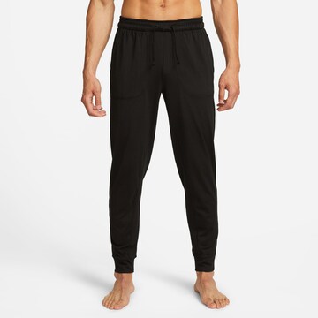 NIKE Tapered Sports trousers in Black: front