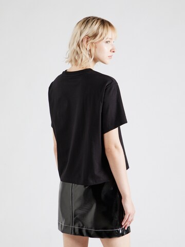 Maglietta di GUESS JEANS in nero