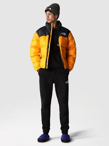 THE NORTH FACE Regular fit Winter Jacket 'M 1996 Retro Nuptse' in Orange