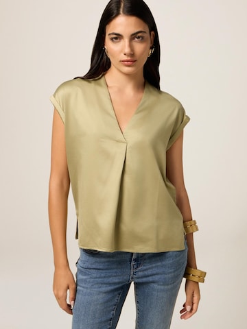 Top di oltre in verde