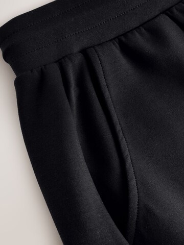 Next - Perna larga Calças em preto