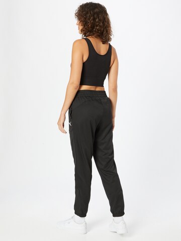 PUMA Tapered Sports trousers in Black