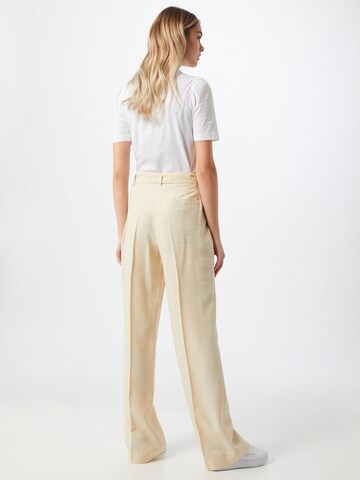 TOMMY HILFIGER Loose fit Trousers with creases 'TOMMY HILFIGER X ABOUT YOU WL BELTED PANT' in Beige