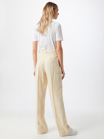 TOMMY HILFIGER Свободный крой Плиссированные брюки 'TOMMY HILFIGER X ABOUT YOU WL BELTED PANT' в Бежевый