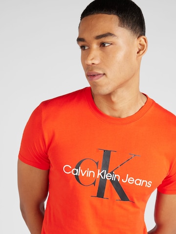 Calvin Klein Jeans قميص بلون برتقالي