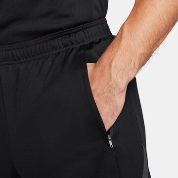 NIKE Regular Workout Pants 'Strike' in Black