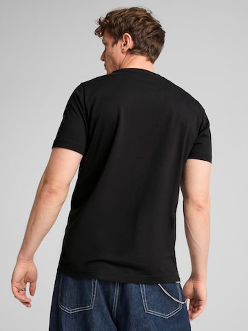 PUMA - Camiseta 'Puma Graphics Wording Tee' en negro