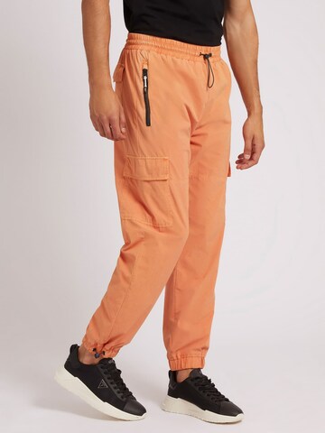 GUESS Cargo Pants in Orange: front