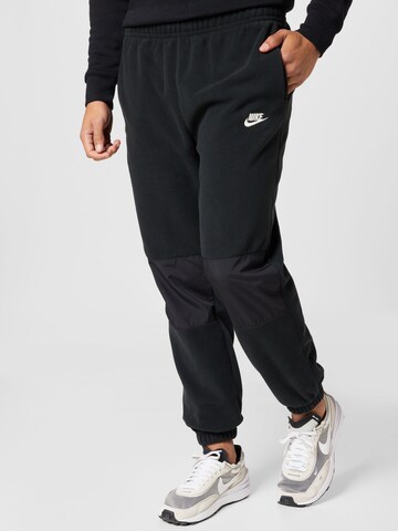 Nike Sportswear Tapered Trousers in Black: front