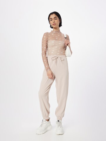 ABOUT YOU Loose fit Trousers 'Romina' in Pink