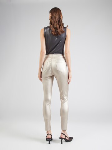 Skinny Jean Cartoon en or