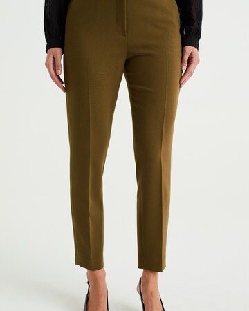 WE Fashion Slim fit Trousers with creases in Green: front