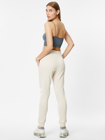 Effilé Pantalon de sport 'Legacy' Hummel en beige