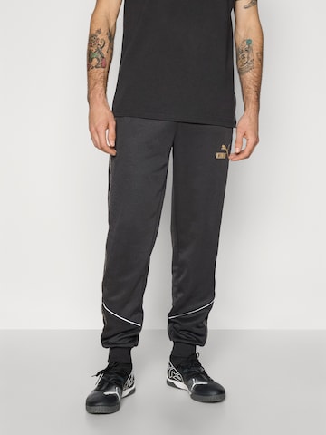 Effilé Pantalon de sport 'KING Anthem' PUMA en noir : devant