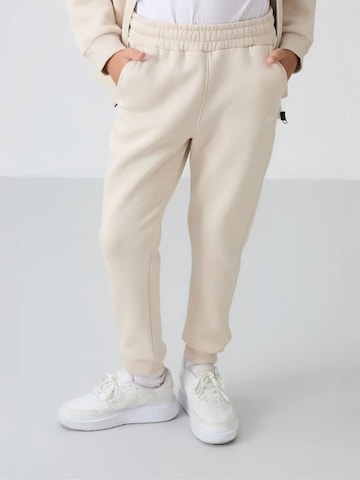 Tommy Life Trainingsanzug 'TOMMY Kinder Active Set'‌‌‌ in Beige