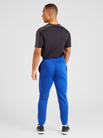 UNDER ARMOUR Zwężany krój Spodnie sportowe 'Essential' w kolorze niebieski