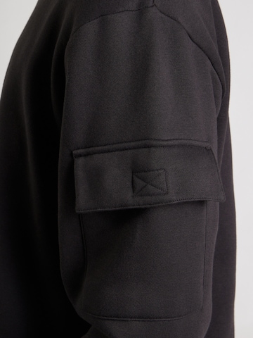 Reebok Urheilullinen collegepaita 'PETER' värissä musta