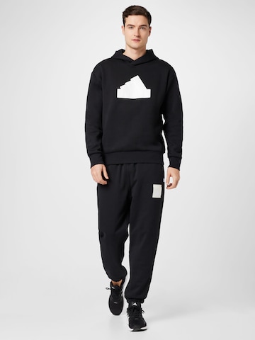 ADIDAS SPORTSWEAR Tapered Παντελόνι φόρμας 'Lounge Heavy French Terry' σε μαύρο
