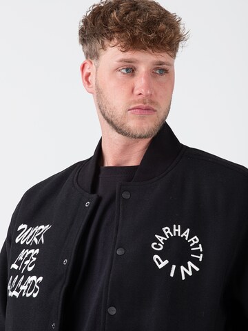 Carhartt WIP Übergangsjacke 'Work Varsity' in Schwarz