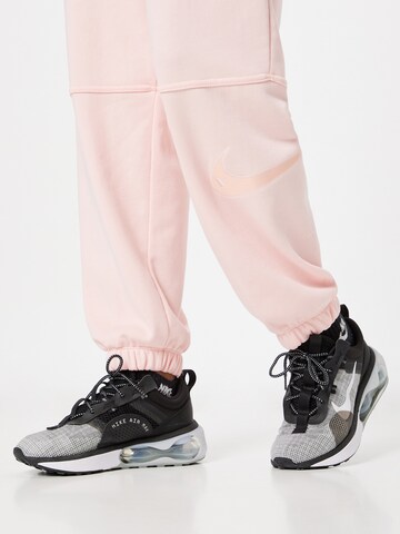Nike Sportswear - Tapered Pantalón en naranja