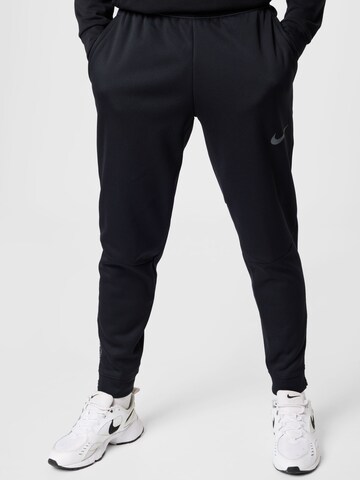 NIKE Конический (Tapered) Спортивные штаны в Черный: спереди