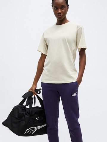 PUMA Tapered Urheiluhousut 'ESS' värissä lila
