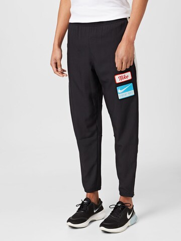 NIKE Tapered Workout Pants in Black: front