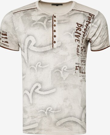 Rusty Neal T-Shirt mit lässigem Allover-Print in Beige: predná strana