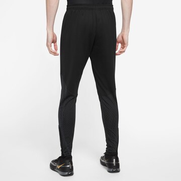 NIKE Slim fit Sports trousers 'Strike' in Black