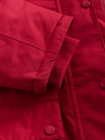 Next Pitkä takki värissä punainen