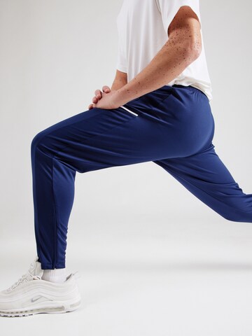 NIKE Tapered Urheiluhousut 'Academy 25' värissä sininen