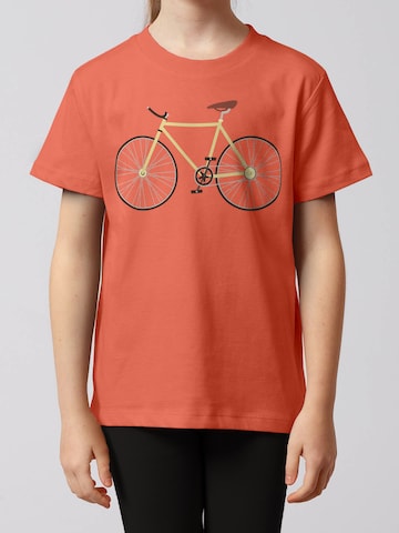 watabout.kids Shirt 'Yellow Bike' in Oranje: voorkant