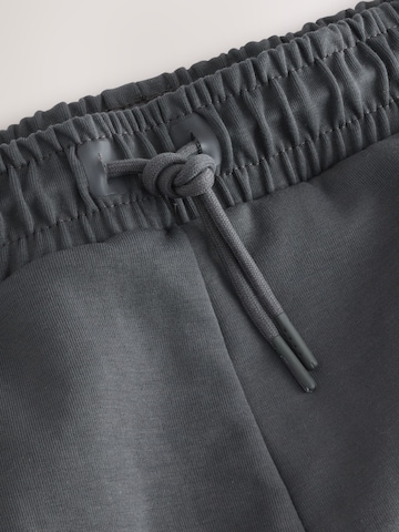 Next Дънки Tapered Leg Панталон в сиво
