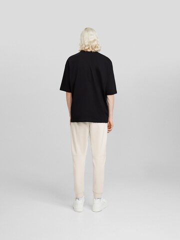 Bershka Дънки Tapered Leg Панталон в бежово