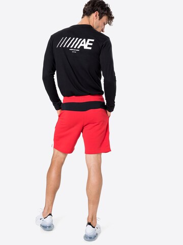 Nike Sportswear - regular Pantalón en rojo