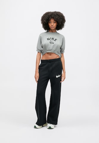 melns Nike Sportswear Platas staras Bikses 'PHNX FLC'