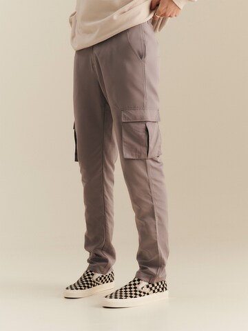 About You x Nils Kuesel Tapered Pants 'Iven' in Grey: front