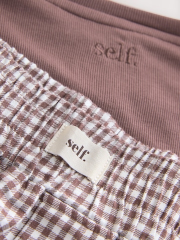 Shorty di self. in marrone