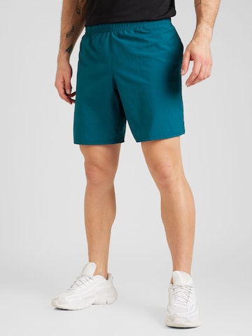 Regular Pantalon de sport 'Gewebte Wdmk' UNDER ARMOUR en vert : devant