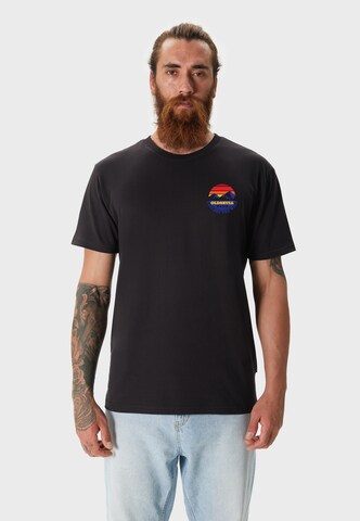 Oldskull T-Shirt 'Wrldvibe Explore The Wild' in Schwarz: Vorderseite