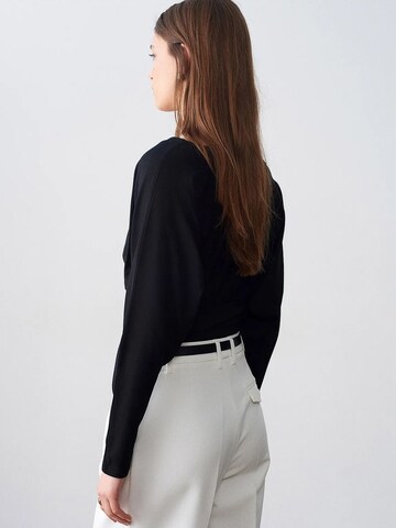 Tapered Pantaloni con pieghe di Dilvin in bianco