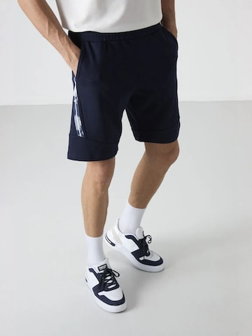 Tommy Life Regular Trousers in Blue: front