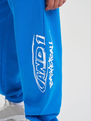 Effilé Pantalon fonctionnel AND1 en bleu