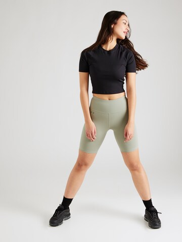 Skinny Pantaloni sport 'Motion' de la UNDER ARMOUR pe verde