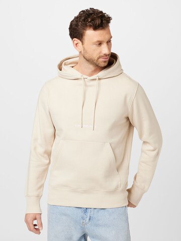 Calvin Klein JeansSweater majica - bež boja: prednji dio