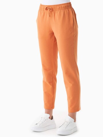 Organication Slim fit Pants in Orange: front
