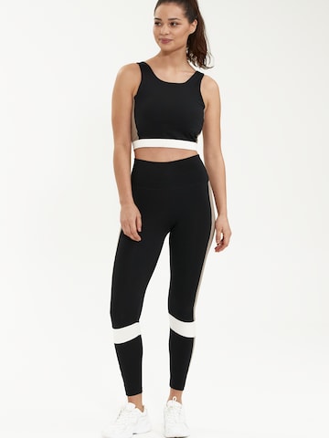 Athlecia Skinny Urheiluhousut 'Comaya' värissä musta