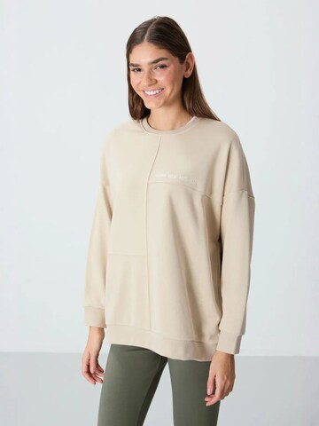Sweat-shirt Tommy Life en beige