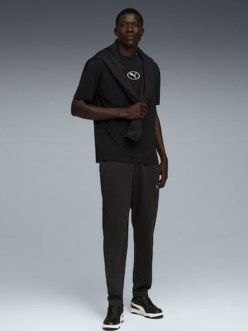 PUMA - regular Pantalón deportivo 'Puma Evostripe Warm Pants' en negro